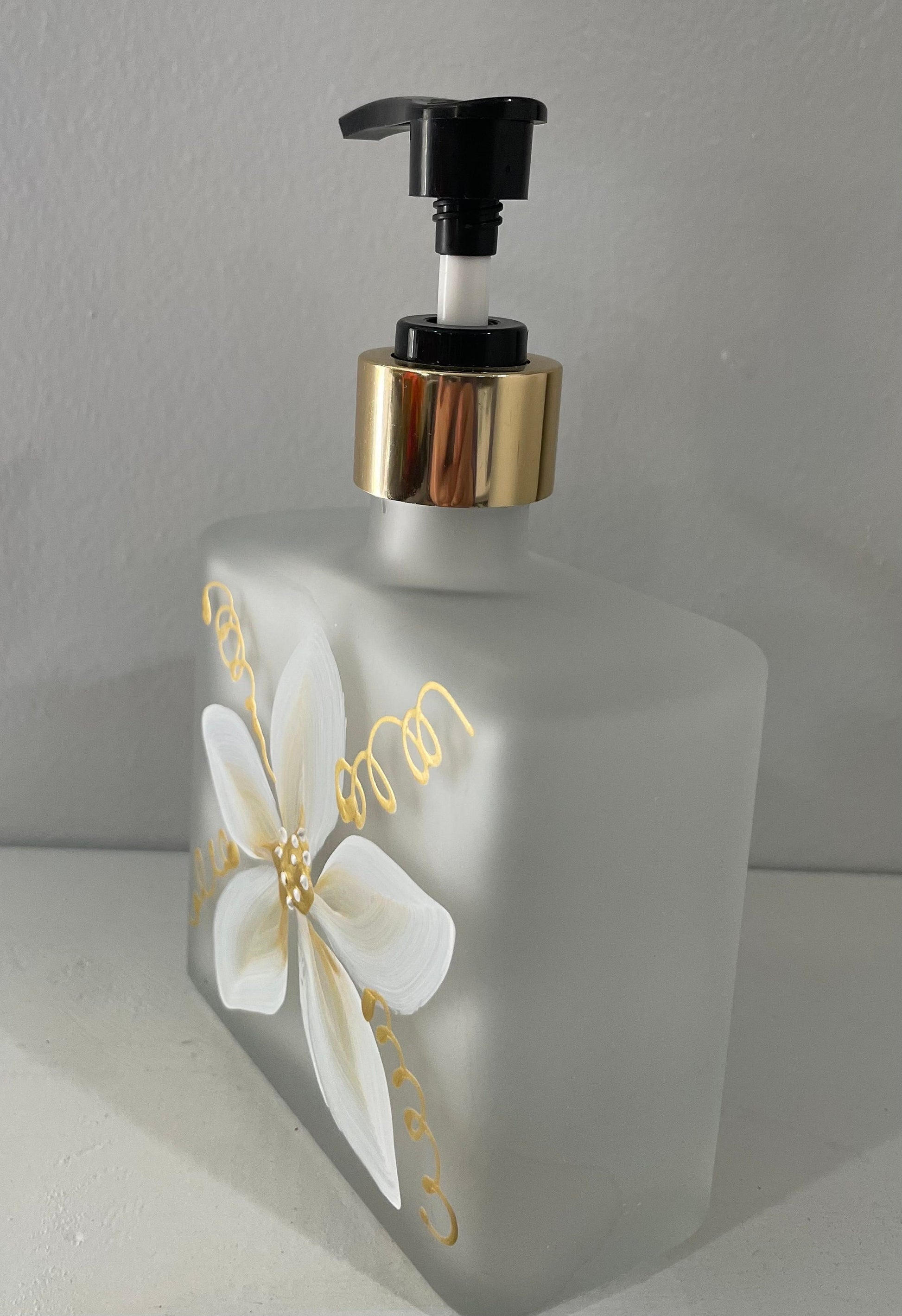 Hand painted Soap or Lotion Dispenser with white and gold flower on both sides of bottle